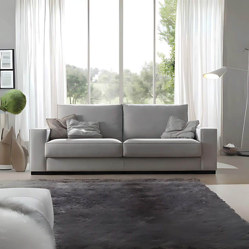 Sofá confortable Diseño con formas rectas amplias medidas armazón de madera de pino sólido de 1″ de espesor y triplay de 15 mm. cojines decorativos acojinamiento en poliuretano flexible densidad suave con aislante térmico aptas de madera barnizadas en color negro Aura Muebles modelo MILAN