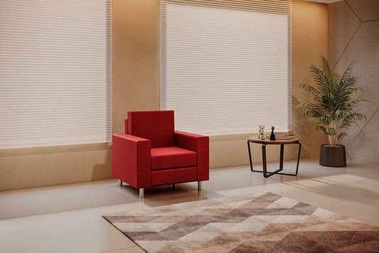 Sillón Rubí de 1 plaza en color rojo colocado en una sala de espera elegante con luz natural.