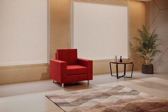 Sillón Rubí de 1 plaza en color rojo colocado en una sala de espera elegante con luz natural.